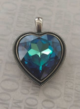 Load image into Gallery viewer, Heart-shaped pendant with blue crystal on a textured background