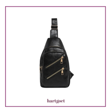 Load image into Gallery viewer, Black imitation leather sling bag with gold zippers on a white background, featuring the brand 'hartgoet'.