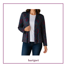 Load image into Gallery viewer, A woman wearing a dark navy cardigan with a red and teal geometric diamond pattern over a white t-shirt and dark blue jeans, shown against a white background with a purple border and the brand name hartgoet below.
