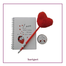 Load image into Gallery viewer, Notebook with a pen and lip balm on a white background with 'hartgoet' branding.