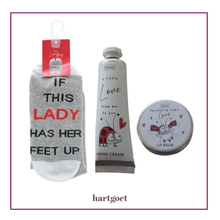 Load image into Gallery viewer, Set of socks, hand cream, and lip balm with ladybug design on a white background