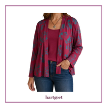 Load image into Gallery viewer, A woman wearing a long-sleeve open-front cardigan in a deep maroon color with a teal abstract floral pattern, layered over a matching magenta top and blue jeans. The brand name 'hartgoet' is printed at the bottom of the image.