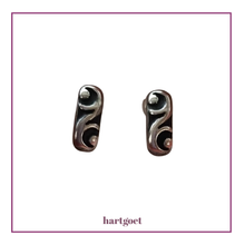 Load image into Gallery viewer, Pair of silver earrings with intricate designs on a white background.