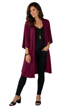 Load image into Gallery viewer, Model wearing a long maroon jacket, black top and pants, on a white background