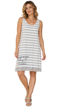 Load image into Gallery viewer, A woman modeling a sleeveless white and gray striped dress with a gray lace hem and the text 'A girl must be 2 things Classy & Fabulous' printed on the front, set against a white background.