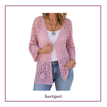 Load image into Gallery viewer, A woman wearing a light pink open-front lace cardigan over a white tank top and blue jeans, shown against a white background with a purple border. The brand name 'hartgoet' appears below the image.