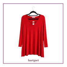 Load image into Gallery viewer, A bright red long-sleeve tunic top with a V-neckline, hanging on a black hanger against a white background with a thin purple border and the brand name 'hartgoet' printed below.