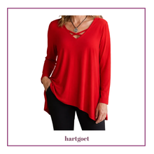 Load image into Gallery viewer, A woman wearing a bright red long-sleeve top with a crossover V-neckline, paired with black pants. The image is presented on a white background with a decorative purple border and the brand name 'hartgoet' printed at the bottom.