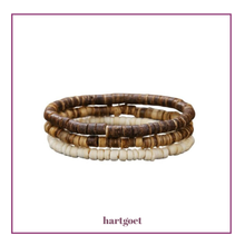 Load image into Gallery viewer, Stack of 3 brown and white beaded bracelets on a white background with 'hartgoet' branding.