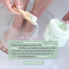 Load image into Gallery viewer, Lady with her feet in a bowl of water, using the Sh'Zen spa additive foot soak, and text with a customer review