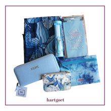 Load image into Gallery viewer, A blue =themed gift, featuring a blue floral scarf, a mini manicure set, a light blue magnetic memopad, a light blue textured wallet with 'ESCAPE' branding, a small patterned coin purse, and a card wallet, arranged on a white background with a purple border.