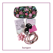 Load image into Gallery viewer, A curated flat-lay of Hartgoet-branded beauty and lifestyle accessories on a white background with a magenta border. The set includes a floral zippered pouch, a notebook,  a tin reading 'Random notes of inspiration, ponytail hair bands, a small mirror, a pink flower-shaped ihair clip and a beaded necklace.
