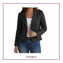 Load image into Gallery viewer, A woman wearing a black blazer with white polka dots, styled over a white top and blue jeans, presented on a white background with a purple border and the brand name 'hartgoet' at the bottom.
