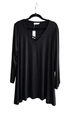 Load image into Gallery viewer, A black long-sleeve V-neck top hanging on a black hanger against a white background
