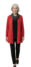 Load image into Gallery viewer, Woman wearing a red cardigan, black top, and pants with a polka dot scarf on a white background
