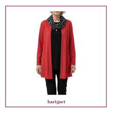 Load image into Gallery viewer, Person wearing a red cardigan over a black top with a polka dot scarf, brand 'hartgoet' visible
