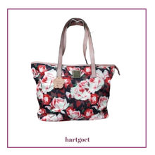 Load image into Gallery viewer, Floral patterned handbag with visible brand name on a white background
