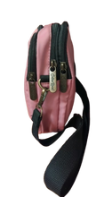 Load image into Gallery viewer, Side view of a small pink Cotton Road cross body bag
