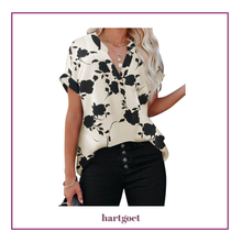 Load image into Gallery viewer, Woman wearing a floral blouse with 'hartgoet' branding
