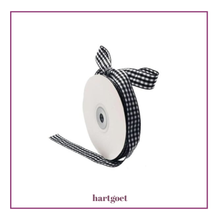 Load image into Gallery viewer, Roll of black and white checkered ribbon with a bow on a white background, branded 'hartgoet'.
