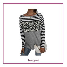 Load image into Gallery viewer, Person wearing a striped sweater with a leopard print section, holding a clutch, on a white background.

