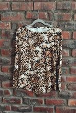 Load image into Gallery viewer, Leopard print top on a hanger with a brick wall background
