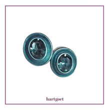 Load image into Gallery viewer, Pair of oval stud earrings with crystals on a white background
