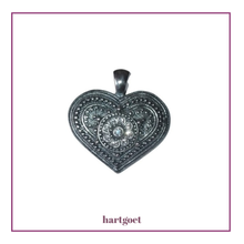 Load image into Gallery viewer, Decorative heart-shaped pendant with intricate designs on a white background.  
