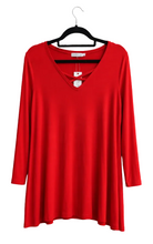 Load image into Gallery viewer, A bright red long-sleeve V-neck tunic top hanging on a black hanger against a white background background.
