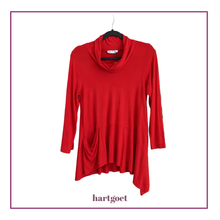 Load image into Gallery viewer, A bright red long-sleeve cowl neck top with a draped, asymmetrical hem, hanging on a black hanger against a white background with a purple border and 'hartgoet' text below.
