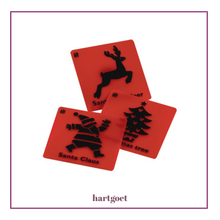 Load image into Gallery viewer, Three red plastic rubbing plates with black Christmas-themed designs on a white background, featuring Santa Claus, a reindeer, and a Christmas tree.
