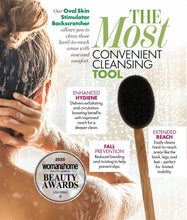 Load image into Gallery viewer, Oval skin stimulator backscratcher with text and awards on a magazine cover.
