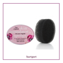 Load image into Gallery viewer, Two black oval bath sponges, one in packaging labeled 'The original skin stimulator not your regular sponge' by Sh'zen on a white background.
