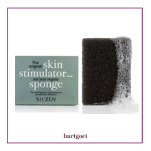 Load image into Gallery viewer, Two black bath sponges, one SH'ZEN packaging, on a white background
