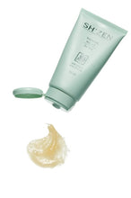 Load image into Gallery viewer, A light mint green tube of SHiZEN Thermal Relief with its cap off, floating above a dollop of pale yellow gel on a solid white background.
