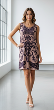Load image into Gallery viewer, Woman wearing a patterned dress in a minimalistic setting
