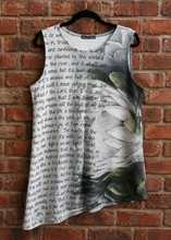 Load image into Gallery viewer, A sleeveless dress featuring a realistic printed flower design, overlaid with black script text, displayed against a red brick wall background.
